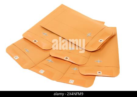 Horizontal close-up shot of seven manila envelopes isolated on white. Stock Photo