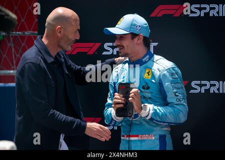 Miami Gardens, United States. 04th May, 2024. Retired French professional footballer Zinedine Zidane greets Monaco's Formula One driver Charles Leclerc of Scuderia Ferrari following his second place in the sprint race during the Formula One Miami Grand Prix at the Miami International Autodrome in Miami Gardens, Florida on Saturday, May 4, 2024 Photo by Greg Nash/UPI. Credit: UPI/Alamy Live News Stock Photo