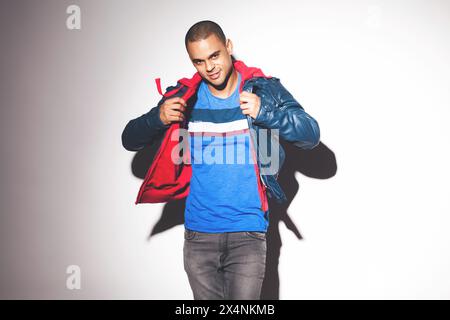 Portrait, man and casual in studio, jacket and pose in fashionable, model and confident. Person, background and stylish with trendy clothes and Stock Photo