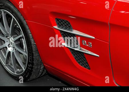 Detailed view of the side ventilation and badge of a red Mercedes-AMG 6.3 sports car, Stuttgart Messe, Stuttgart, Baden-Wuerttemberg, Germany Stock Photo