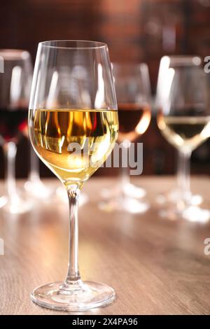 Tasty wine in glass on wooden table Stock Photo