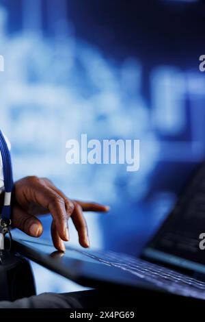 IT consultant writes code on tablet to visualize artificial intelligence neural networks using augmented reality, close up. High tech establishment manager runs AI script for information processing Stock Photo