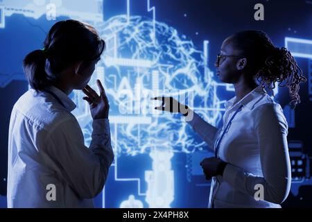 Certified engineers brainstorm ways to use AI cognitive computing to extract usable information from complex data. Teamworking experts implement artificial intelligence to process massive datasets Stock Photo