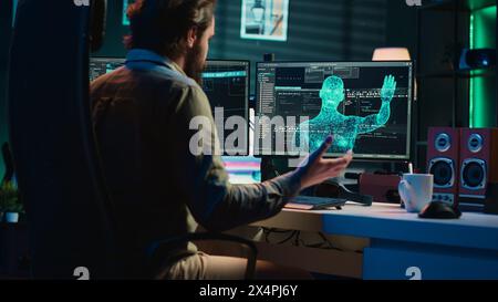 Man feeling speechless after seeing AI gaining anthropomorphic form and consciousness, waving hand to salute him. Computer engineer surprised by sentient artificial intelligence greeting him, camera A Stock Photo