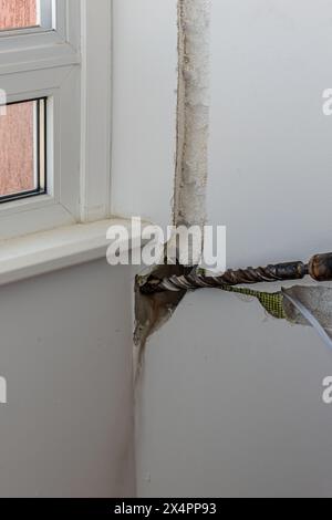 Technician of the air conditioning system is drilling Lviv Ukraine 08.04.24 Stock Photo