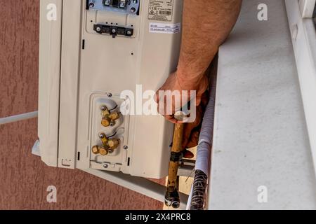 Installing an air conditioner in an apartment office Lviv Ukraine 08.04.24 Stock Photo