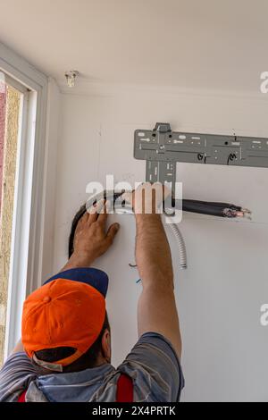 Installing an air conditioner in an apartment office Lviv Ukraine 08.04.24 Stock Photo