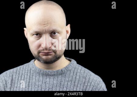 This is a compelling portrait of a man, set against a stark white ...