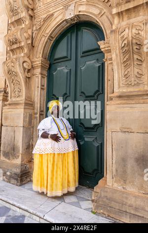 Portrait of a Bahian woman in traditional baiana dress at the Church of the Third Order of Saint Francis, Pelourinho district, Salvador, Bahia, Brazil Stock Photo