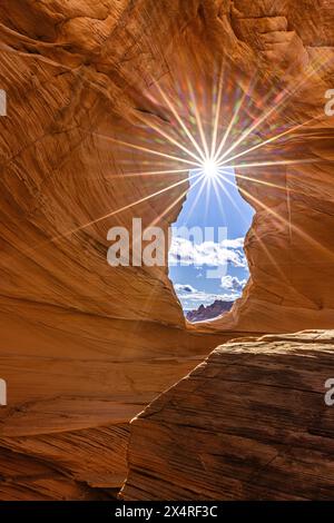 Sunburst in Melody Arch at Marble Canyon during sunrise near The Wave, Coyote Buttes North, Vermilion Cliffs National Monument, Arizona, USA Stock Photo