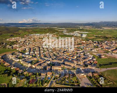 Aerial view of the town of Santpedor and the green fields of Pla de Bages on a spring sunset (Barcelona, Catalonia, Spain) Stock Photo