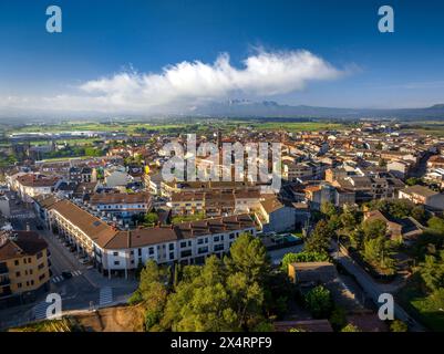 Aerial view of the town of Santpedor on a spring morning with some high fogs (Bages, Barcelona, Catalonia, Spain) Stock Photo