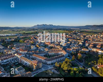 Aerial view of the town of Santpedor on a spring sunrise. In the background, the Montserrat mountain (Bages, Barcelona, Catalonia, Spain) Stock Photo