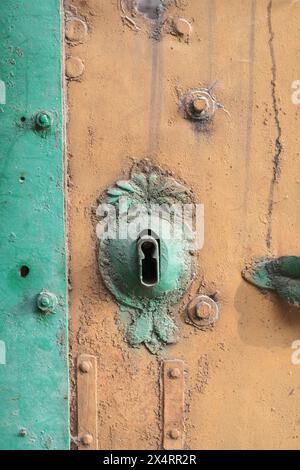 ornate keyhole on weathered metal door in Kulpin, Backi-Petrovac, Serbia Stock Photo