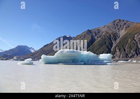 This iceberg is located in Tasman Lake at the terminal of the massive Tasman Glacier - New Zealand. Tourists can cruise up close to the glaciers. Stock Photo