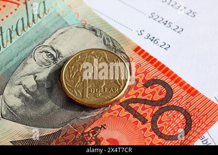 Australian twenty dollar note with one dollar coin with financial number background. Stock Photo