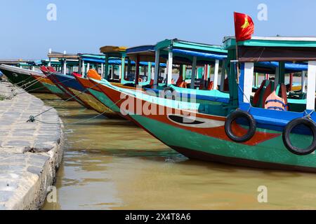 A group of colourful boats moored at Hoi An - Vietnam. Boats such as these are iconic of the seaside port of Hoi An in Vietnam. Hoi An is a very popul Stock Photo