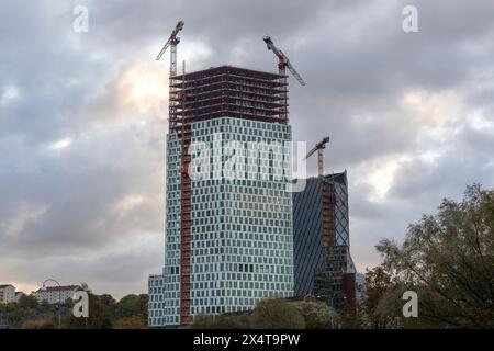 Gothenburg, Sweden - Oct 15 2021: Two high rise buildings under construction with cranes and some workers visible. Stock Photo