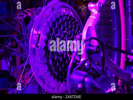 Close up of bicycle gears under a purple light Stock Photo