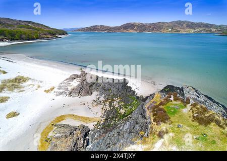 Silver Sands of Morar Highland Scotland blue sky over cove and sandy beach and turquoise sea at high tide Stock Photo