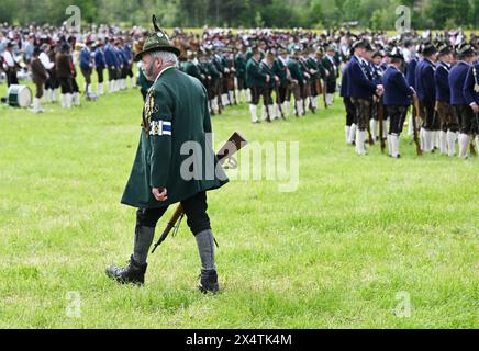 Lenggries, Germany. 05th May, 2024. Men in traditional costume follow the service for the patron saint's day of the Bavarian mountain marksmen. Around 4000 marksmen celebrate in honor of the Mother of God, who is their patron saint. Credit: Angelika Warmuth/dpa/Alamy Live News Stock Photo