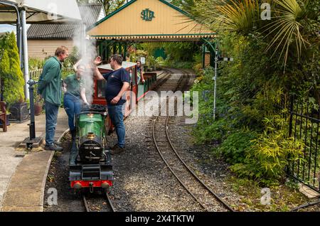 Volunteers ready The Railway Mission minature steam locomotive and its carriages at South Downs Light Railway, Pulborough, UK Stock Photo