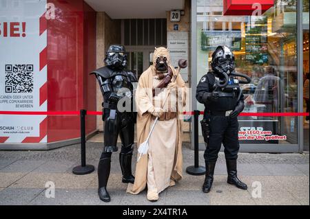 04.05.2024, Berlin, Germany, Europe - Star Wars fans of the fandom dressed in various costumes stand in front of the Lego Store on Tauentzienstrasse. Stock Photo