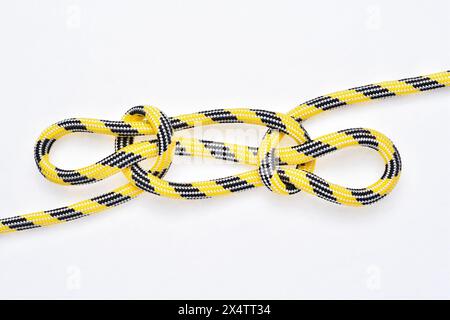 Sheepshank knot on yellow and black nylon rope on white background. Stock Photo