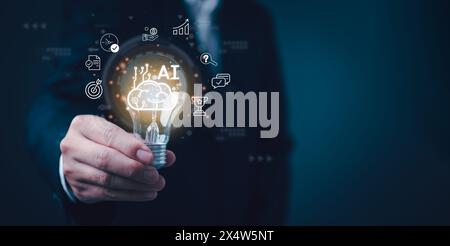 A person holds a light bulb with AI and innovation icons holographically projected around it. The image symbolizes the bright future of AI technology. Stock Photo