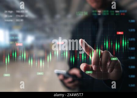 Businessperson pointing to stock market buy and sell signals on a digital screen. Stock Photo