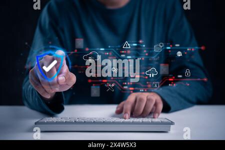 A hand interacts with digital cybersecurity elements over a keyboard, cloud cybersecurity and protection hacker data network digital technology inform Stock Photo