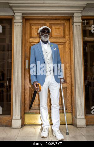 London, UK.  5 May 2024.  An elegantly dressed man takes part in the fourth Grand Flâneur walk. Starting at the Beau Brummell statue on Jermyn Street, the walk coincides with the 25th anniversary of The Chap magazine and is defined as a walk without purpose, celebrating the art of the flâneur, oblivious to going anywhere specific, and an antidote to the demands of modern life and the digital smartphone.  Credit: Stephen Chung / Alamy Live News Stock Photo