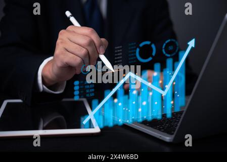 Data analysis graph and chart investment and marketing concept. Businessperson analyzing financial market trends on digital interface. Stock Photo