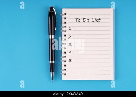 To do list text on notepad on blue background Stock Photo