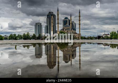 The water reflection of the Grozny City skyscrapers and the 'Heart of Chechnya' mosque in the downtown of Grozny, the capital of Chechnya, Russia Stock Photo