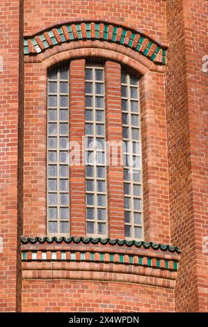 Vintage tower building made of orange bricks. Lovey plastic texture facing on the building. Stock Photo