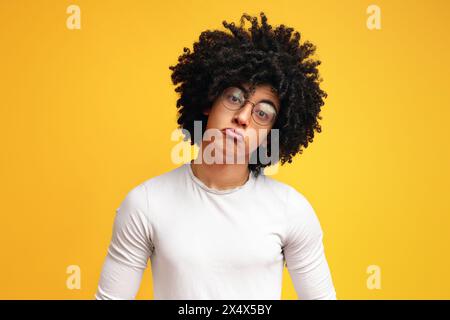Funny upset african guy pouting lips, looking offended Stock Photo