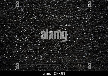 Black porous porous foam background. Background texture of black foam rubber Stock Photo