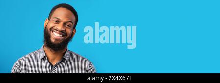 Smiling black man portrait on blue background Stock Photo