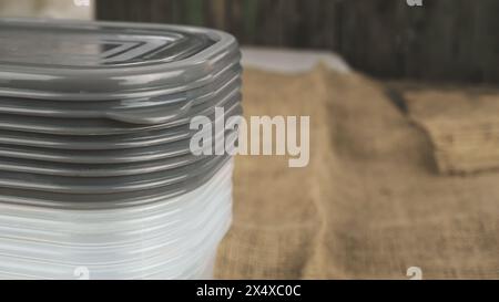A stack of plastic food containers on the right with coipy space on the right. Plastic tupperware storage food boxes. Stock Photo