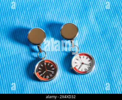 nurse watch FOB with label, studio shot on blue stripes background Stock Photo