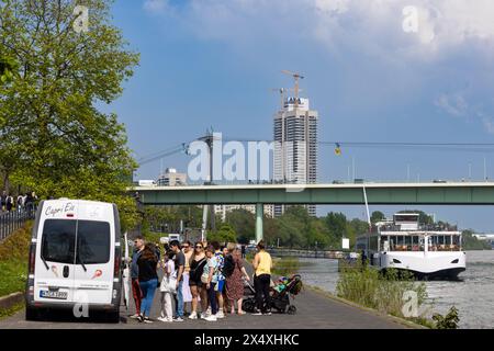 People enjoying warm spring weather on Rhine Promenade in Cologne Stock Photo