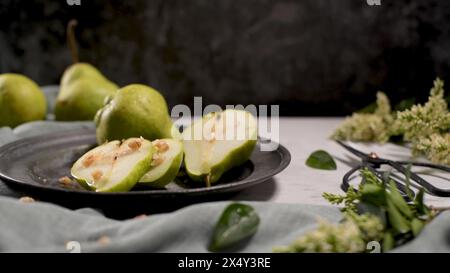 Metal plate with delicious ripe pears on table. Stock Photo