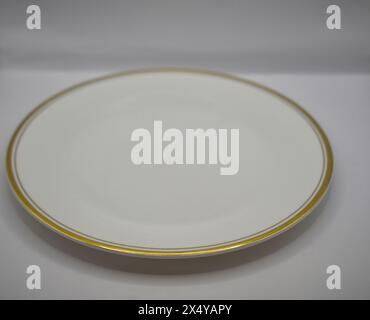 white dinner plate with gold rim Stock Photo