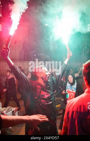 Istanbul, Turkey. 05th May, 2024. A man holds flares during the march. Hundreds of people marched in Istanbul on the evening of May 5th to express their solidarity with the Palestinian people. The demonstrators condemned Israeli attacks and called for an immediate ceasefire and humanitarian aid access. The march echoed global calls for peace in the region. Credit: SOPA Images Limited/Alamy Live News Stock Photo