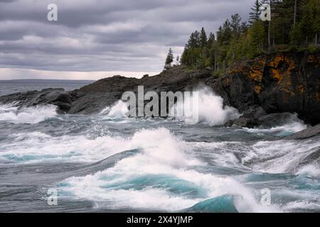 Autumn storm driven waves on Lake Superior crash against the Black Rocks at Presque Isle Park in Michigan's Upper Peninsula and Marquette County. Stock Photo