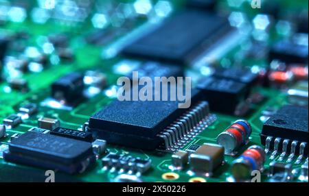 Closeup of Printed Circuit Board with processor, integrated circuits and many other surface mounted passive electrical components. Stock Photo