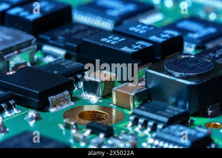 Closeup of Printed Circuit Board with processor, integrated circuits and many other surface mounted passive electrical components. Stock Photo