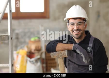 Happy construction worker looking at camera in a house Stock Photo
