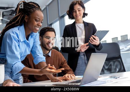 Businesspeople smiling while being together in a co-working space working on new project Stock Photo